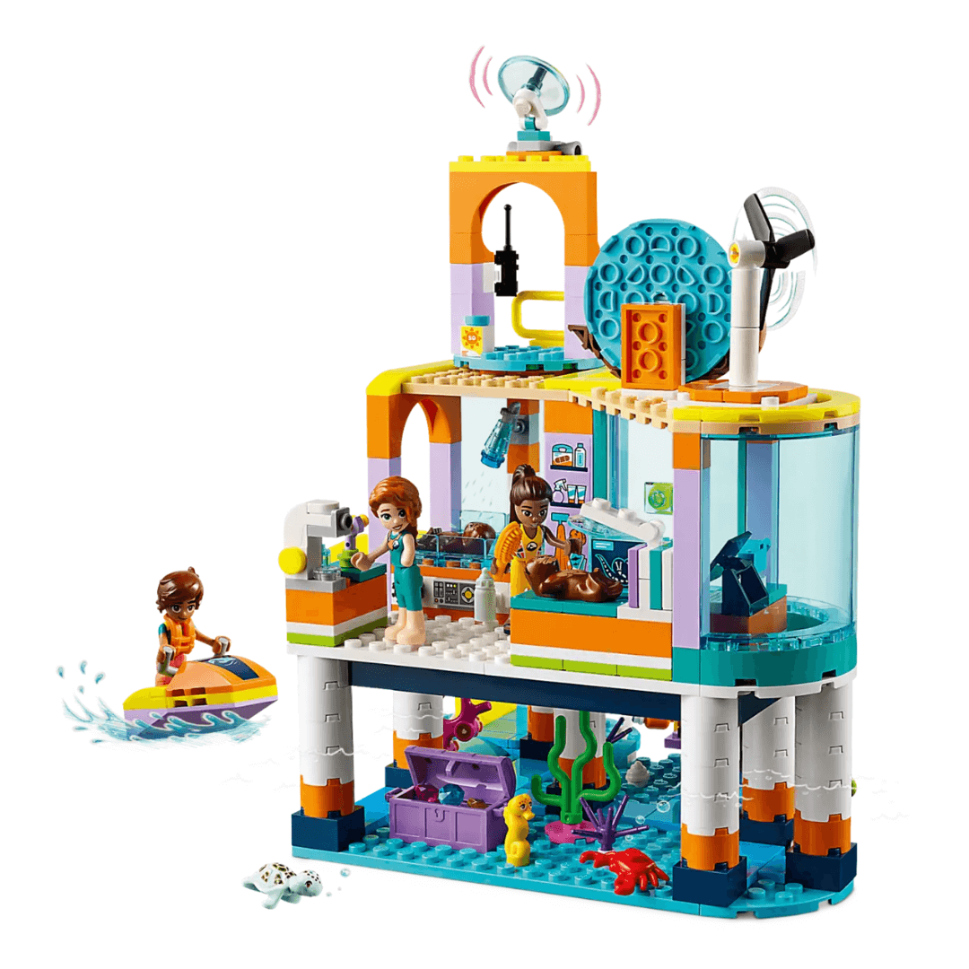 41736 Lego Friends Sea Rescue Centre Built Set. 2 Story Open Building. Bottom Story Open To Ocean, A Crab, Seahorse And Turtle Sit Next to An Open Treasure Chest. Second Story Is A Mediacl Centre, 2 Characters Attend To Sealife In Xray Machine. A Jetski Is Seen Next To The Building With Character Riding.
