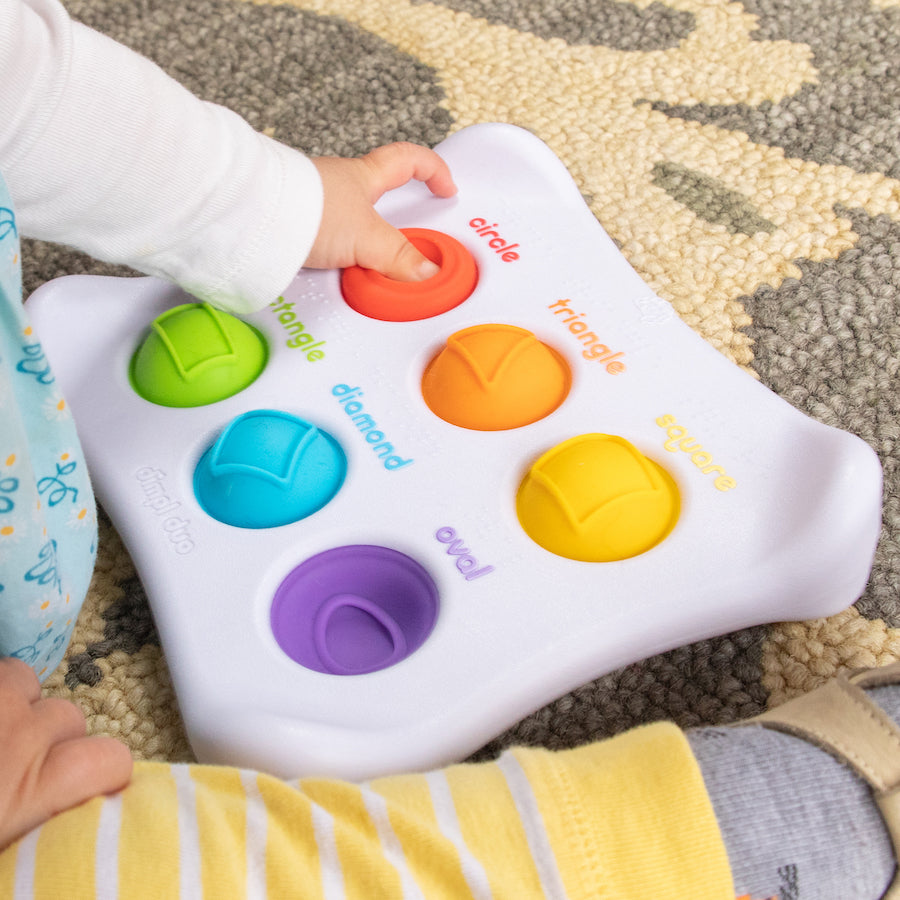 Child playing with Fat Brain Toys Dimpl Duo out of box