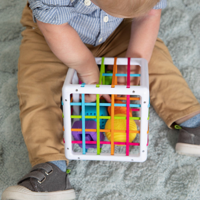 Fat Brain Inny Bin with Childs hand playing