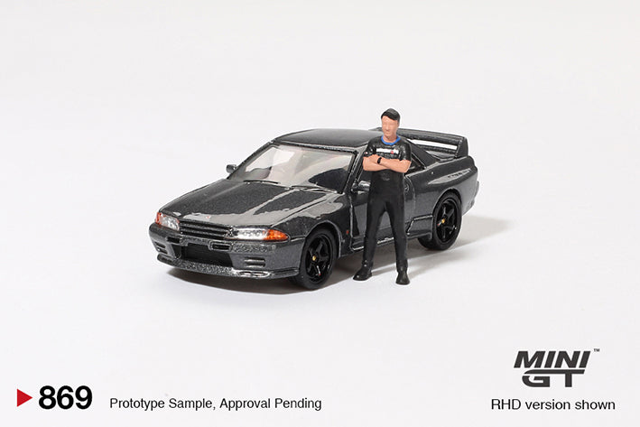 Mini GT - 1:64 Nissan Skyline GT-R R32 Nismo Gunmetal with Matsuda Figure Tsugio Matsuda Collection