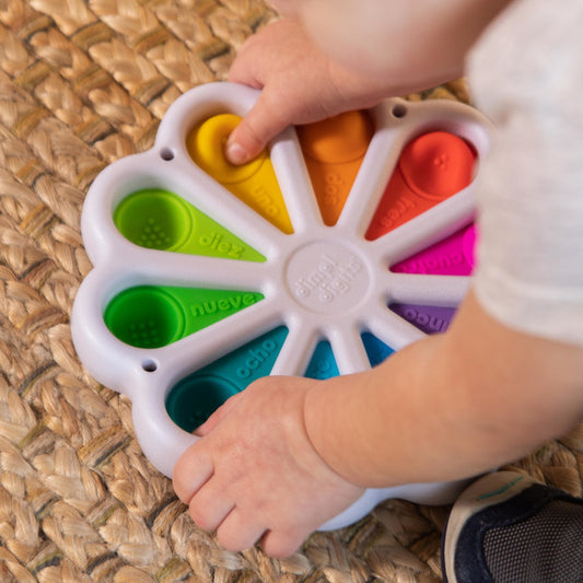 Child holding Fat Brain Toys Dimpl Digits out of box